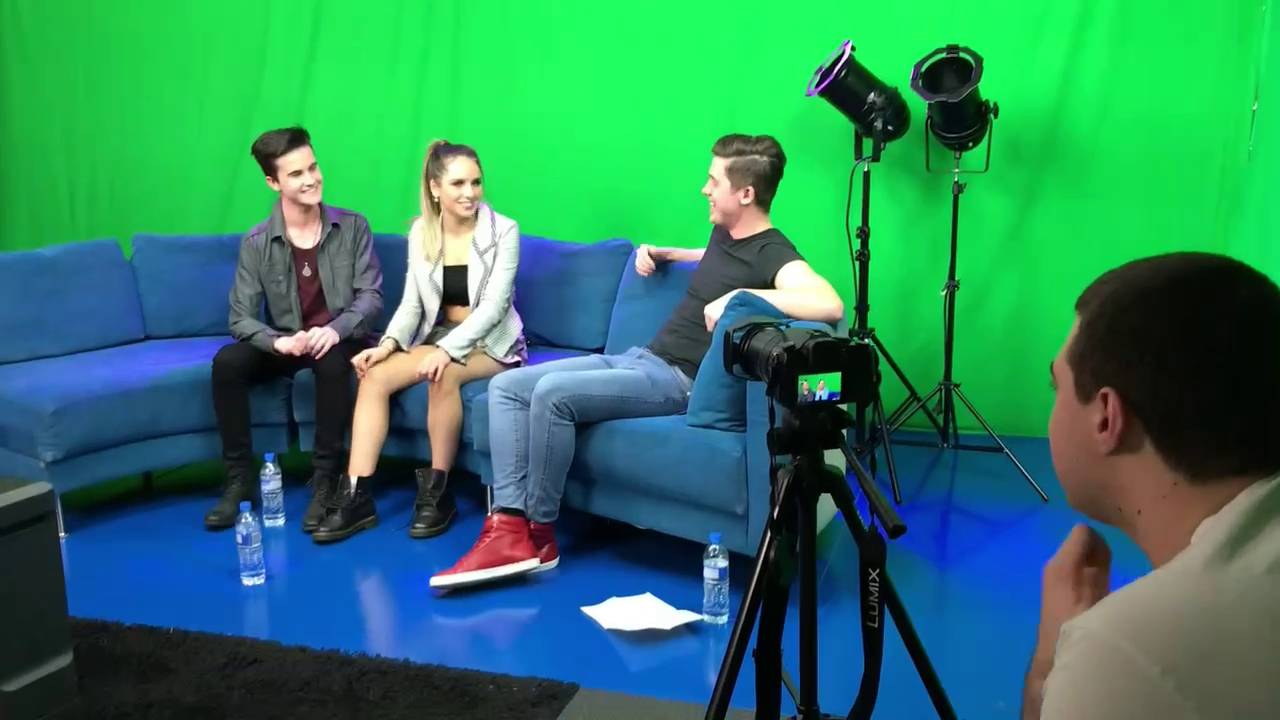 In the studio filming the music show host and guests
