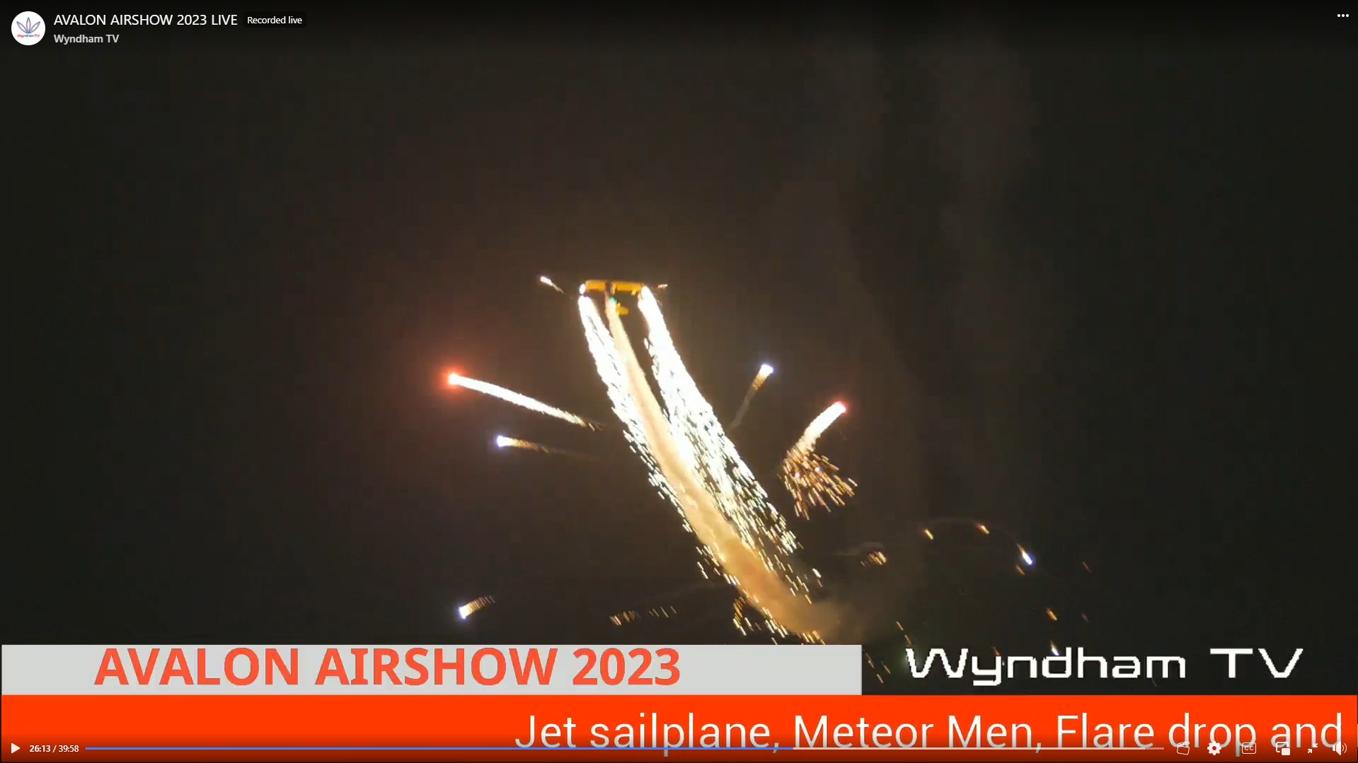 Screenshot from my livestream that shows a plane in flying in the night sky releasing pyrotechnics
